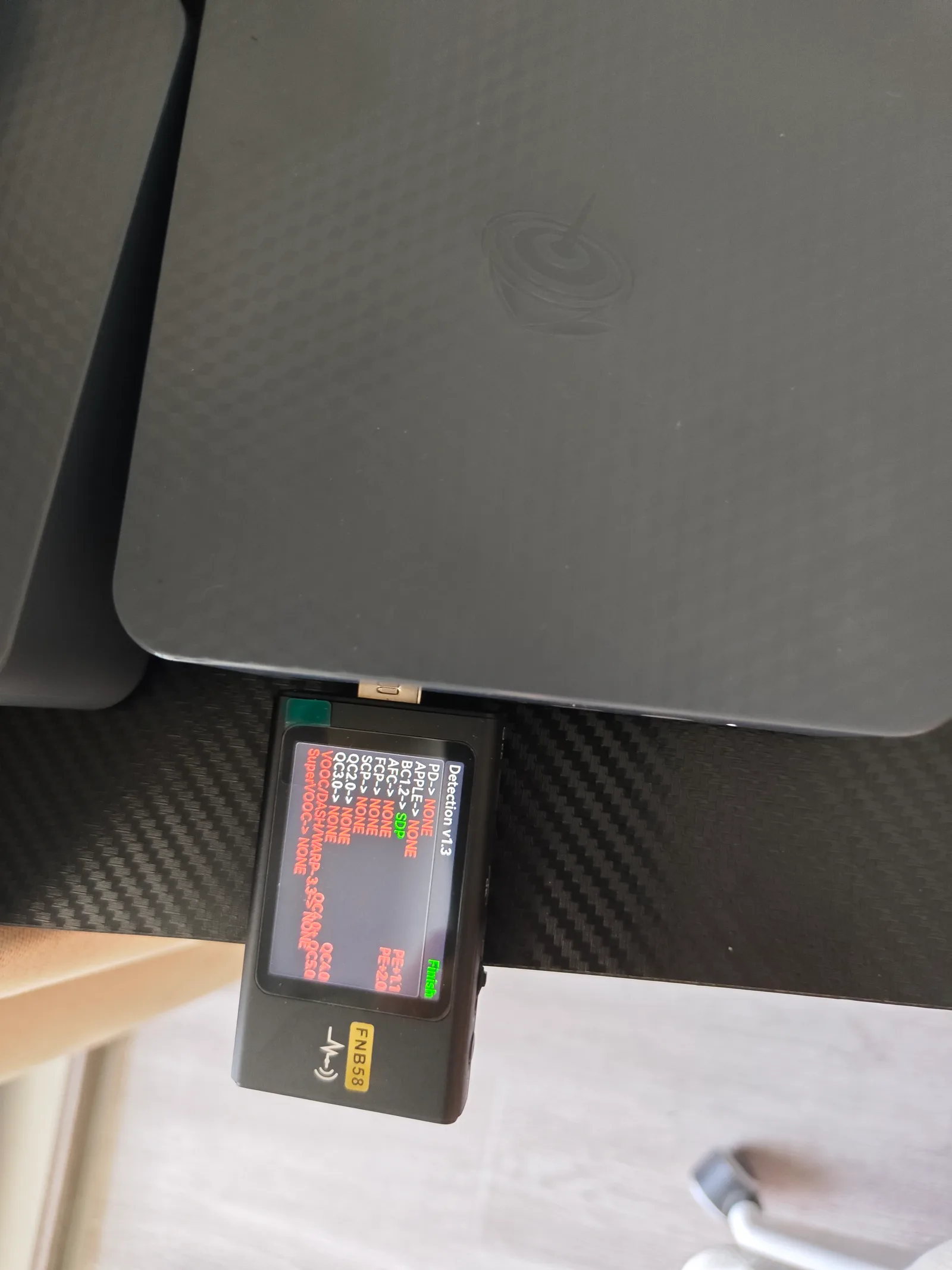 Top-down view of wall power meter alongside EQi12 units during testing